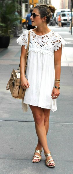 Pleated swing mini dress with white lace sleeves and gold strappy sandals