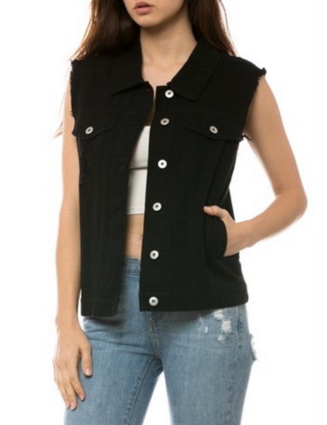 unwashed black denim vest with white crop top and blue torn jeans