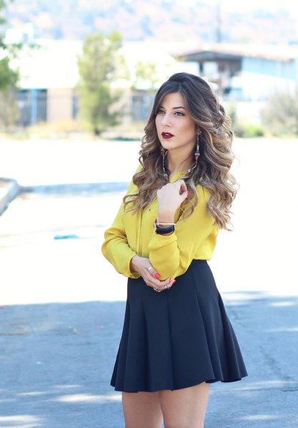 Mustard-colored shirt with buttons and black mini-skirt