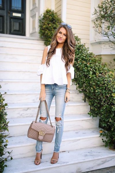 white chiffon blouse with cold shoulder and torn slim fit jeans