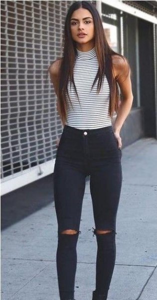 sleeveless top with black and white striped stand-up collar and high jeans