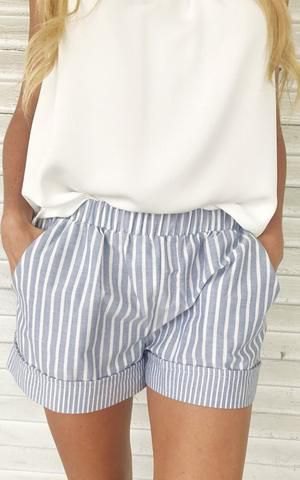 white sleeveless top with a relaxed fit and gray striped mini shorts with elastic waist