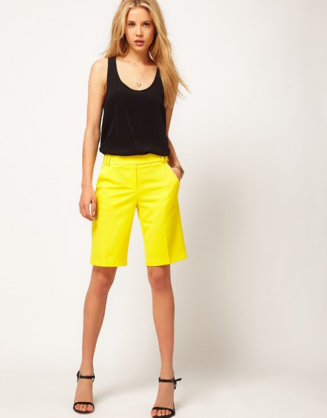 black sleeveless tank with a scoop neckline and yellow shorts