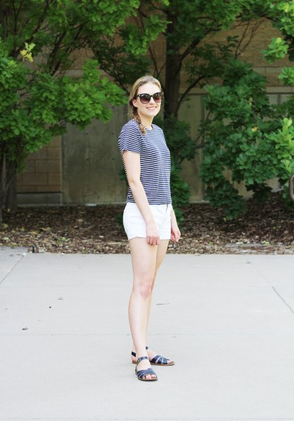 striped T-shirt with white mini cotton shorts and black slip sandals