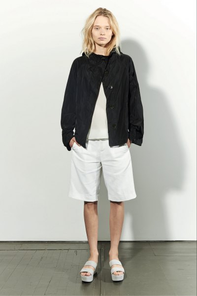 black bomber jacket with light pink sweater and white long shorts