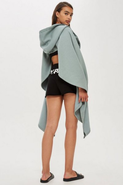 gray draped hoodie with cut out back and black mini running shorts