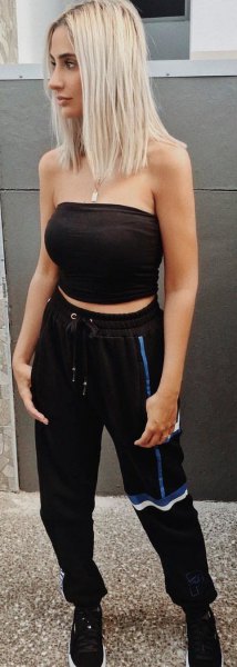 black, short tube top with sweatpants and sneakers with a tapered leg