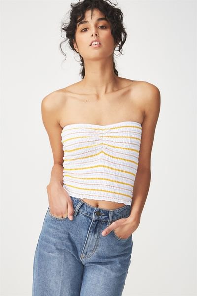 white and orange striped short tube top with blue straight leg jeans