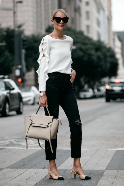 Neckline of white sweater with ankle-black jeans and pink heels