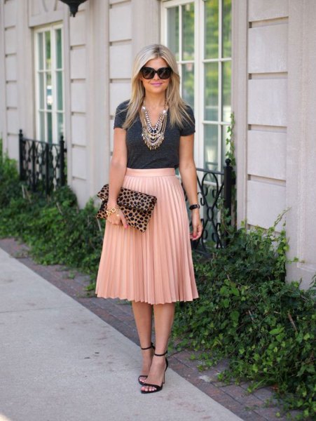 gray t-shirt with rose gold colored high rise pleated skirt