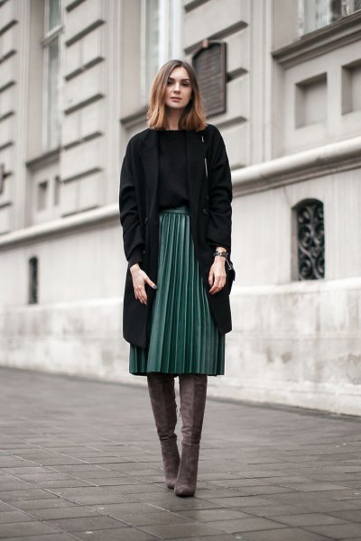 black longline blazer with gray pleated skirt and thigh-high boots