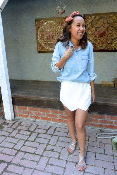 light blue shirt with buttons and white mini skirt