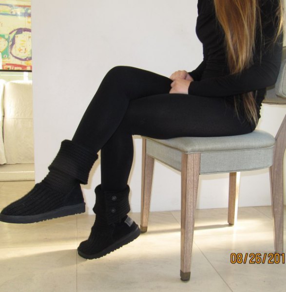 black figure-hugging sweater with matching boots in the middle of the calf