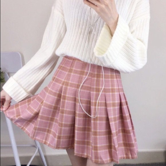 white ribbed knit sweater with red, pleated, checkered mini skirt