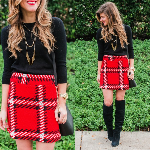 black sweater with three-quarter sleeves and red mini skirt made of checkered wool with high waist