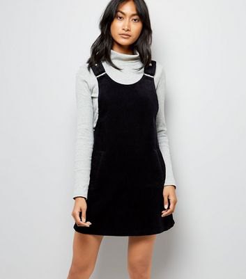 light gray mock neck sweater with black strap dress