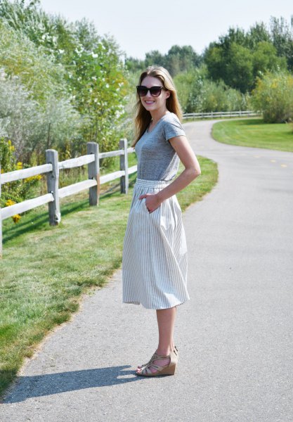 gray short-sleeved T-shirt with vertical striped midi skirt