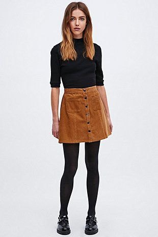 black mock-neck sweater with half sleeves and brown cord mini skirt with button placket