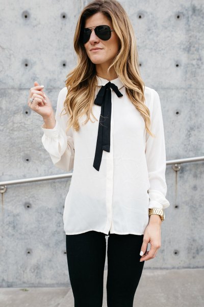 white and black chiffon shirt with tie neck and skinny jeans