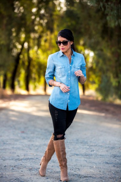 Light blue denim shirt with black jeans and knee high boots with camel heel