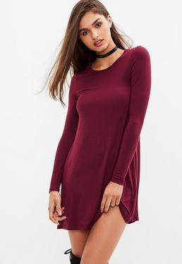burgundy, long-sleeved, figure-hugging t-shirt dress with over the knee boots