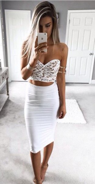 white crop top with a heart-shaped neckline and a high-waisted, form-fitting midi skirt