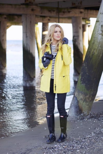 yellow rain jacket with black and white striped t-shirt and boots