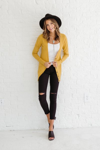 yellow cardigan with white scoop neck and ripped skinny jeans
