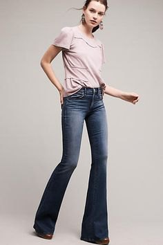 light pink t-shirt with dark blue low rise jeans