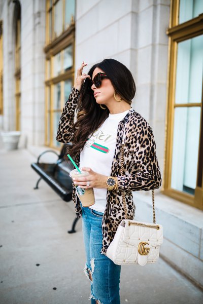 white tee with leopard print jacket and ripped blue jeans