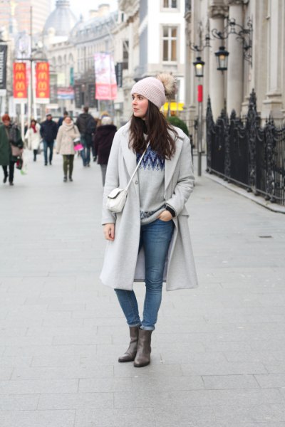 gray knitted hat and matching long winter coat and cuffed jeans