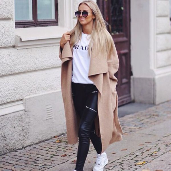 camel maxi length winter coat with white print tee and black leather pants
