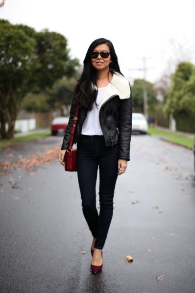 black flying jacket with white faur fur collar and skinny jeans