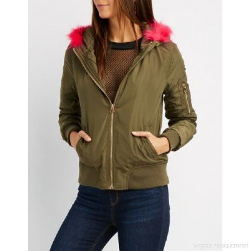 green bomber jacket with net blouse and jeans