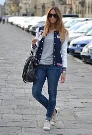 navy blue and white college jacket with low top sneakers