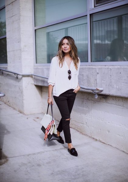 white half-heated casual blouse with black ripped slim fit jeans and loafers