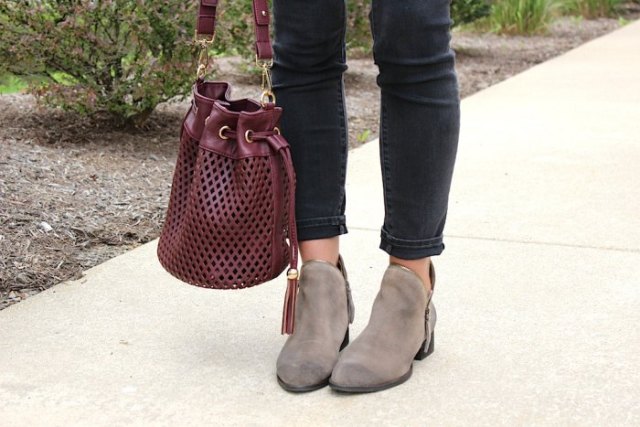 burgundy soft leather handbag with white blouse and black slim ankle jeans