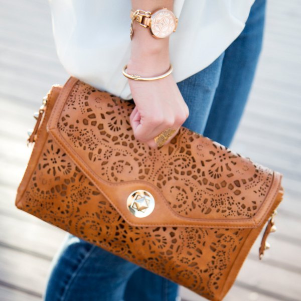 brown cutout bag in soft leather with white chiffon blouse and blue jeans