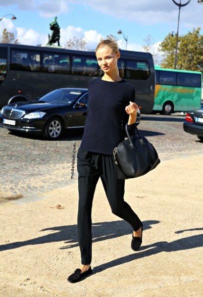 navy blue sweater with black tapered leggings and black suede