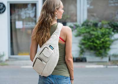 green top with ivory bag and light blue jeans
