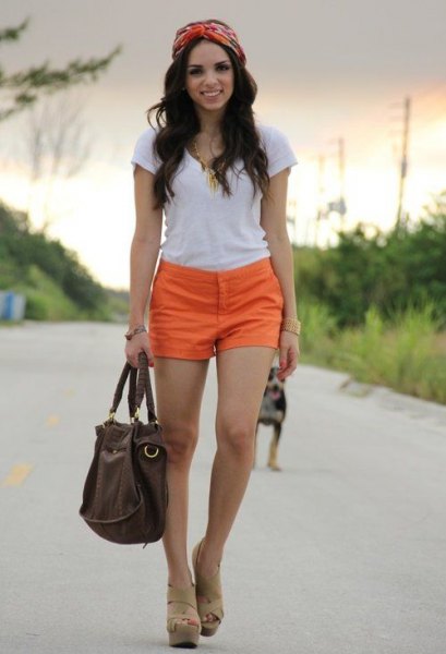 white tee with orange shorts and nude sandals