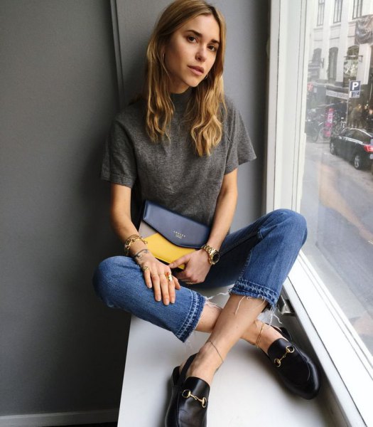 gray t-shirt with blue cropped jeans and leather slip on the boards