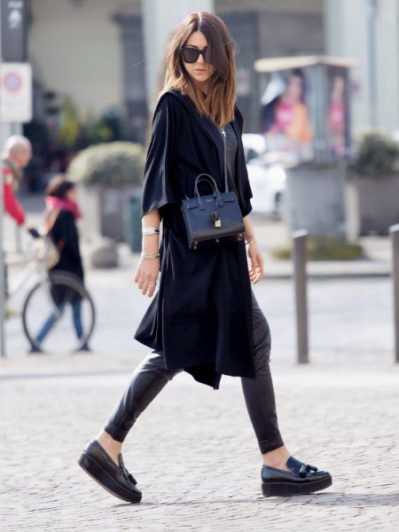 black half sleeve trench coat with leather leggings and loafers