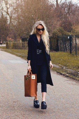 black long-line wool coat with leather platforms