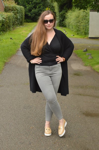 black wrap blouse with gray slim fit jeans and blush pink loafers