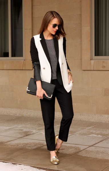 black blazer with white long vest and gold metallic loafers