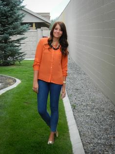 orange button up shirt with blue slim fit jeans and metallic shoes