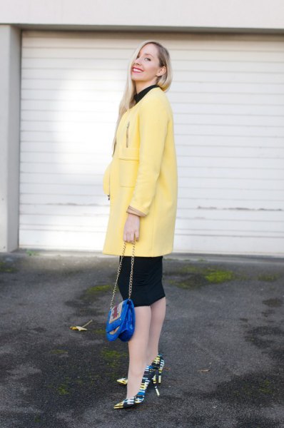 light yellow long wool coat with black knit length dress