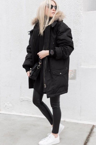 long oversized winter black jacket with dark gray skinny jeans and white sneakers