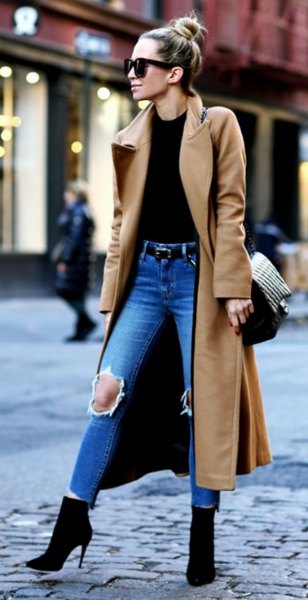 camel maxi length wool coat with black top and ripped blue jeans